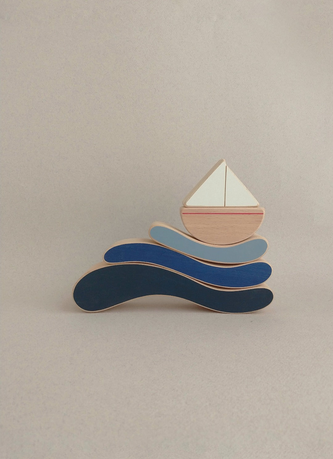 The boat & waves stacking toy is a minimalistic design that combines soft curves and colours with satin smooth natural wood surfaces.