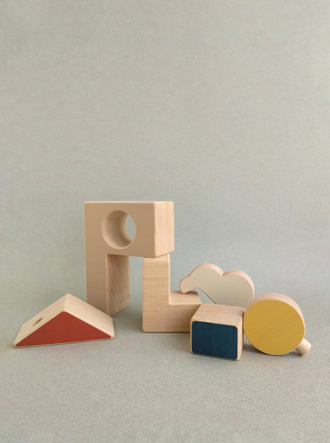 This wooden toy puzzle house combines geometries, vivid colors and satin smooth natural wood surfaces.