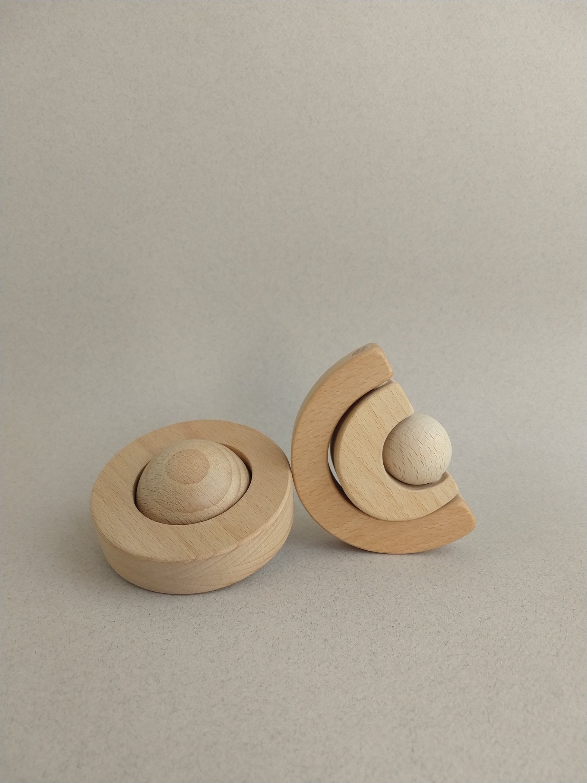 A minimal yet playful wooden teether for babies.