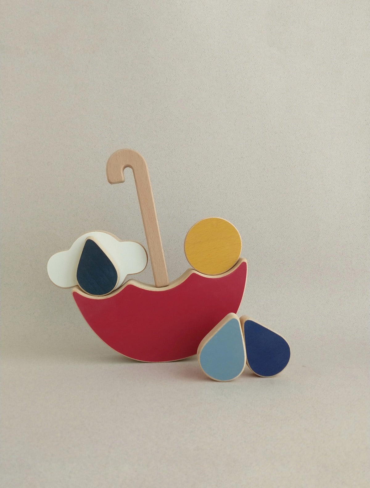 The red umbrella is a minimalist & playful wooden balance toy for toddlers.