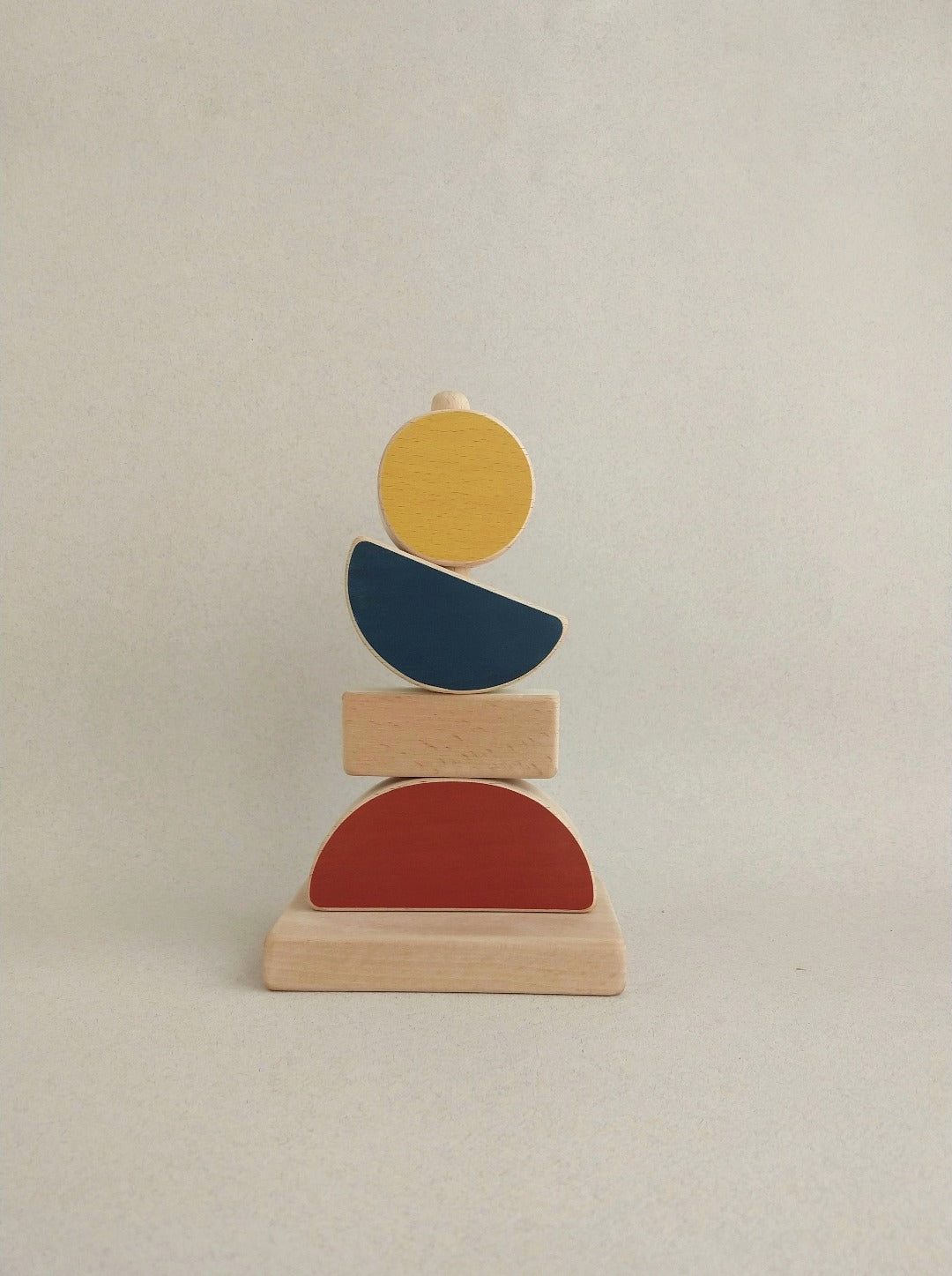 A high-quality & eco-friendly wooden toy with abstract forms (mountain, horizon, moon and sun)and earthy tones.