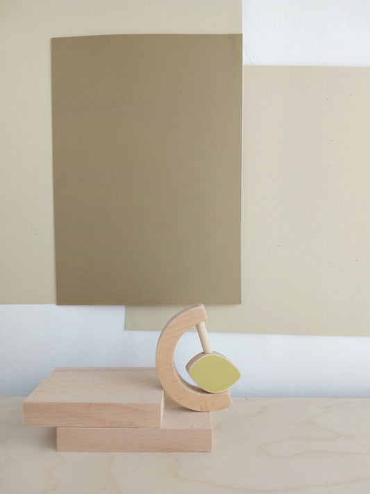 Wooden teether and rattle toy for babies with a minimalistic yet playful design.
